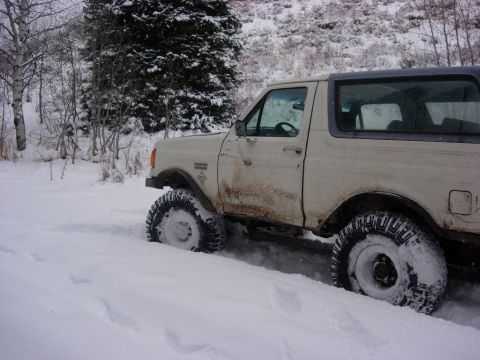1987 Ford Bronco - This white Ford Bronco appears to be from the early 1990s, not 1987, as it is stuck in deep snow.