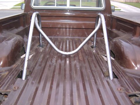 1985 Ford Ranger - The bed of a brown 1985 Ford Ranger pickup truck features a chrome roll bar installed behind the cab.