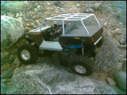 1988 Ford Bronco - This RC crawler navigates a challenging rocky landscape.