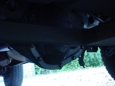 1983 Ford Bronco - The underside of a vehicle is shown, focusing on the differential and part of the exhaust system.