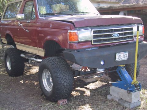 1990 Ford Bronco - This lifted 1990 Ford Bronco is supported by a jack and blocks for maintenance.