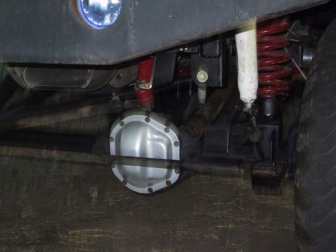 1990 Ford Bronco - Close-up of the suspension components and rear differential of an off-road vehicle.