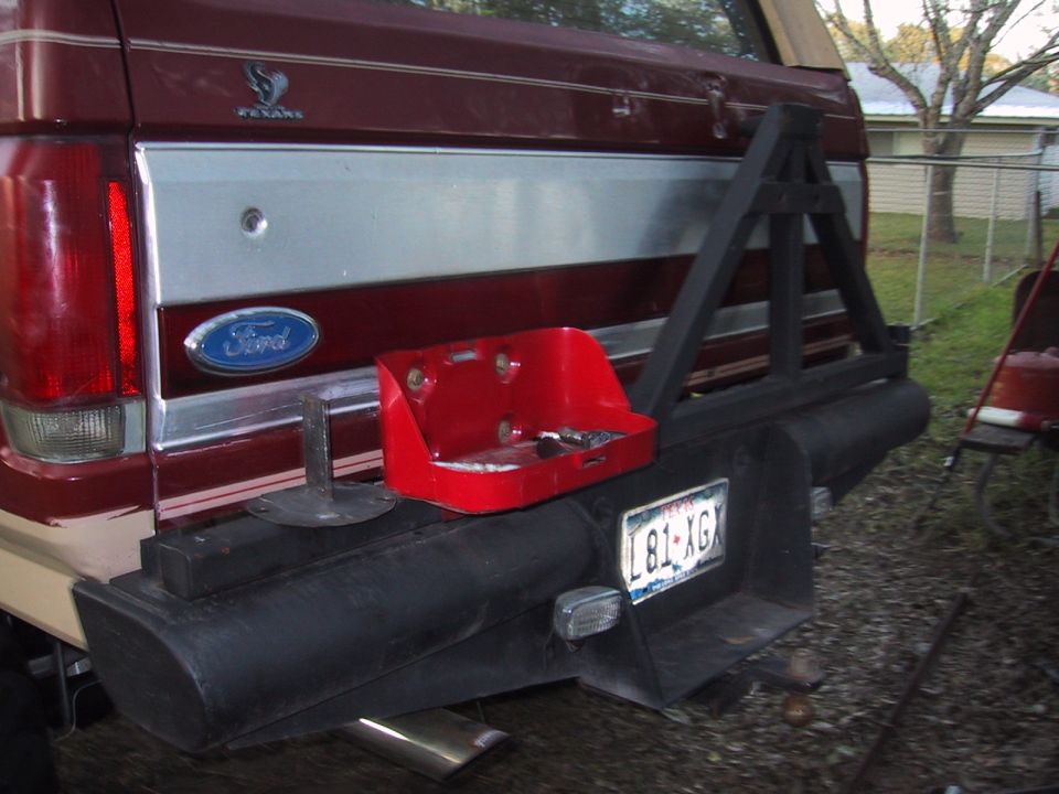 Red Ford Bronco rear bumper with a mounted spare tire carrier and a red toolbox