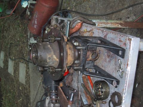 1990 Ford Bronco - Vehicle hub and suspension components are laid out on a workbench with various tools.
