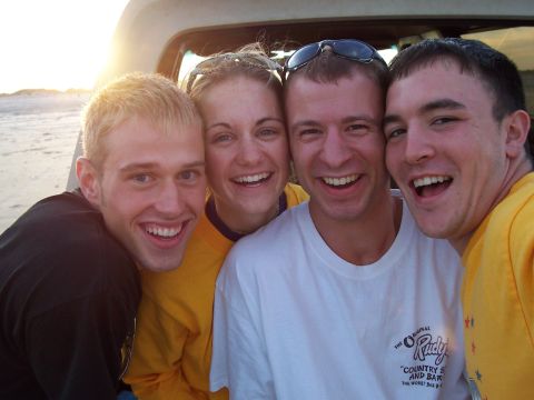 1989 Ford Bronco - A group of friends enjoys a sunny day at the beach, posing for a photo from inside a vehicle.