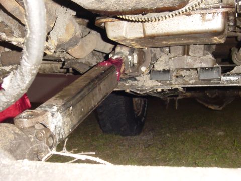 1989 Ford Bronco - Underside view of a vehicle's driveshaft and transmission, showing mechanical components and a tire.