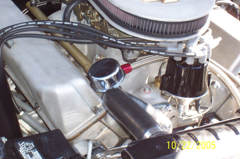 Silver V8 engine bay with K&N air cleaner, MSD plug wires, black distributor and braided line