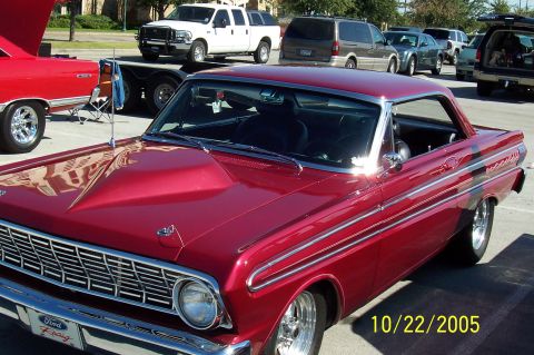 1969 Ford Ranchero - Red 1964 Ford Falcon at an outdoor car show, with other vehicles present.