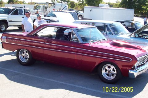 1969 Ford Ranchero - A maroon 1963 Ford Falcon is parked at an outdoor event with other cars visible.