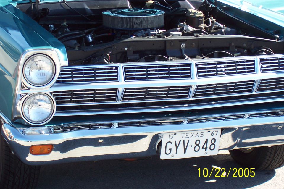 Turquoise 1967 Ford front end with quad headlights, chrome grille and Texas plate GYV 848