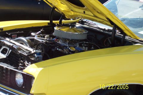 1969 Ford Ranchero - The engine bay of a yellow 1969 Ford Ranchero is visible with the hood open, a chrome air cleaner and MSD ignition box.