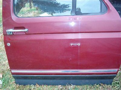 1991 Ford Bronco - This is a red Ford Bronco door, likely from the early 1990s, shown outdoors.