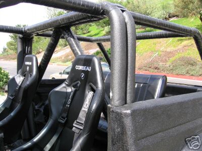 1991 Ford Bronco - Interior view of a vehicle with racing seats and a custom roll cage.