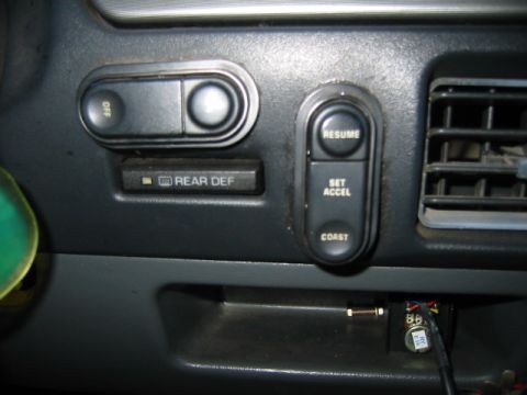1992 Ford Bronco - Interior view of dashboard switches, including rear defroster and cruise control buttons.