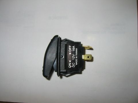 1992 Ford Bronco - A close-up view of a black automotive rocker switch with visible text indicating its function and specifications.