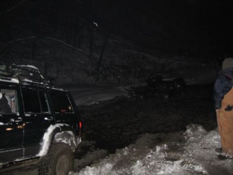 1992 Ford Bronco - Off-road vehicles navigate snowy terrain at night, with multiple vehicles visible in the scene.