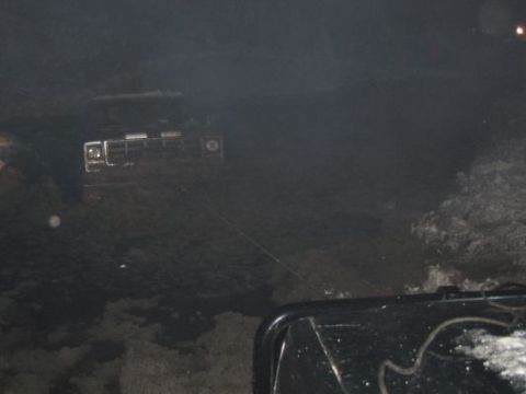 1992 Ford Bronco - The front grille and headlights of a 1992 Ford Bronco are visible in this dimly lit photograph.