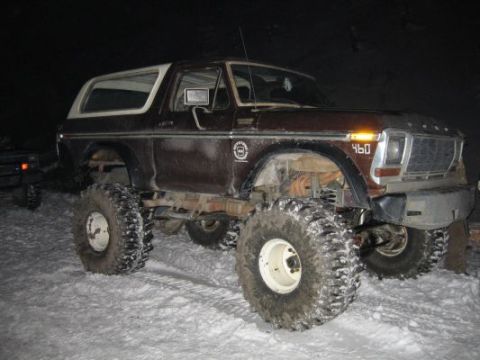 1992 Ford Bronco - This lifted Ford Bronco sits in the snow, its large tires ready for off-road adventure.