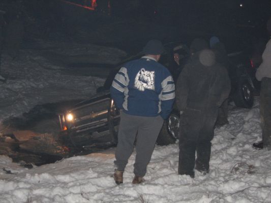 Truck stuck in snow, front wheel visible