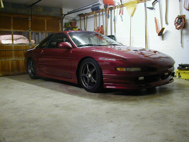 1994 Ford Probe coupe parked in a garage, front 3/4 view