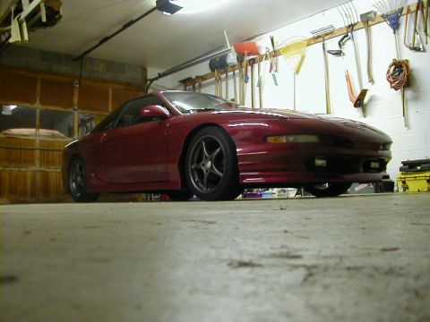 1994 Ford Probe - A red 1994 Ford Probe sits in a garage, ready for its next drive.