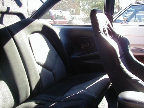 1994 Ford Probe - Interior view shows racing seats, with a red pickup truck and another vehicle visible through the windows.