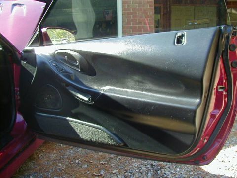 1994 Ford Probe - Close-up view of the interior door panel of a car.