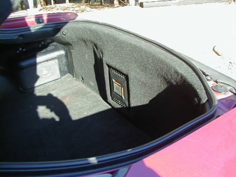 1994 Ford Probe - The trunk of a car shows custom speaker enclosures mounted on the side panel.