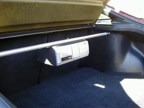 1994 Ford Probe - A CD changer is mounted in the trunk of a vehicle.