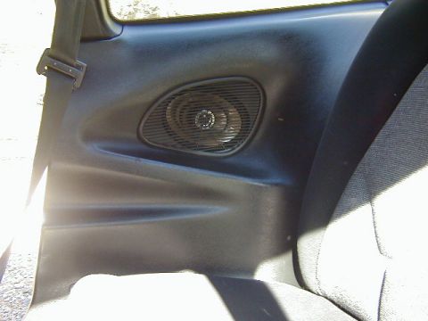 1994 Ford Probe - Interior view of a car's door panel, showing a speaker and seatbelt.