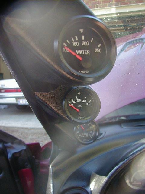 1994 Ford Probe - Aftermarket gauges are installed in the car's interior, showing water, oil, and turbo readings.