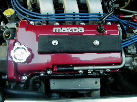 1994 Ford Probe - Close-up of a red engine cover with the Mazda logo and blue spark plug wires visible.