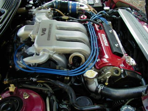 1994 Ford Probe - The engine bay features a V6 DOHC 24-valve engine with blue spark plug wires and a red Mazda branded valve cover.