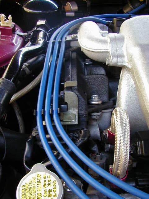 1994 Ford Probe - Close-up view of an engine bay, focusing on spark plug wires and intake components.