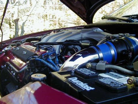 1994 Ford Probe - Close-up view of a car's engine bay, showing the battery and intake system.