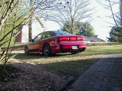1994 Ford Probe - Rear view of a red 1994 Ford Probe parked on a lawn.