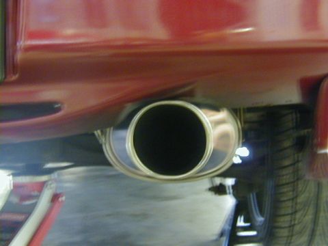 1994 Ford Probe - The rear exhaust pipe is visible on this red vehicle, with a Supermotors.net watermark in the corner.