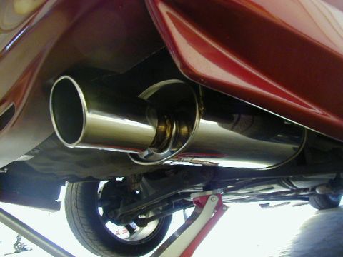 1994 Ford Probe - Underside view of a vehicle's exhaust system and suspension, supported by a jack.