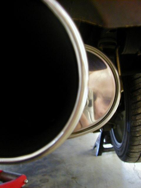 1994 Ford Probe - A car's exhaust pipe and tire are visible while the vehicle is supported by jack stands.