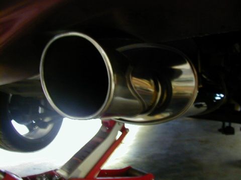 1994 Ford Probe - Exhaust system part shown with a floor jack supporting the vehicle.