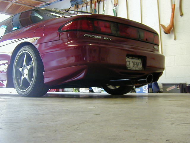 Red 1994 Ford Probe rear view with custom wheels and exhaust