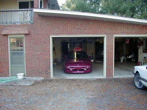 1994 Ford Probe - A purple 1994 Ford Probe is parked in a garage, with a white car visible to the right.