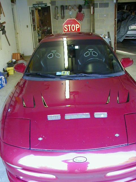 1994 Ford Probe - Red 1994 Ford Probe parked in a garage, racing seats and a stop sign on the roof.