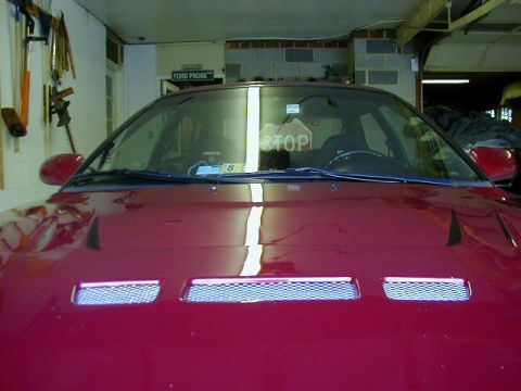 1994 Ford Probe - The front of a red 1994 Ford Probe is visible, parked in a garage.