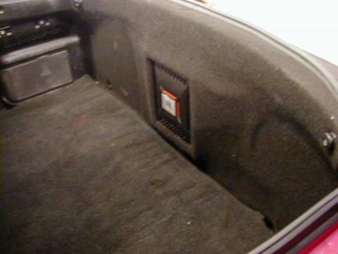 1994 Ford Probe - The interior of a car trunk shows a JBL speaker and carpeted surfaces.