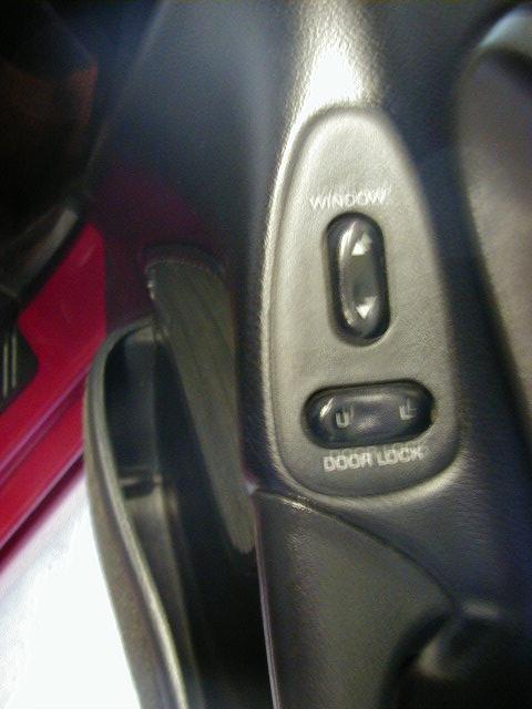 1994 Ford Probe - Interior shot of a car's door panel, focusing on the power window and door lock controls.