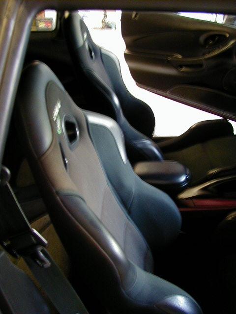 1994 Ford Probe - The interior features racing seats with prominent green accents and a dark dashboard.