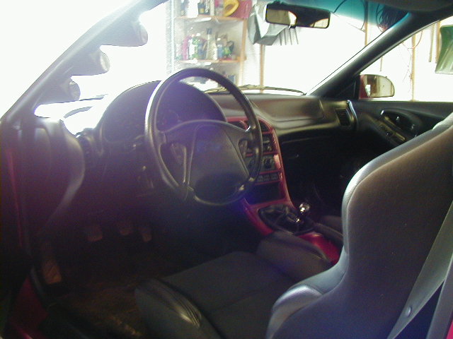 1994 Ford Probe interior with black seats, red trim, and a steering wheel
