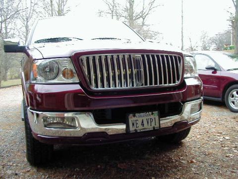 1994 Ford Probe - A maroon SUV is parked in front of a red sedan, with a license plate reading WE 4 VPI.