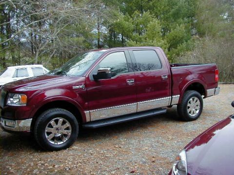 1994 Ford Probe - This red Ford F-150 pickup truck is parked outside with other vehicles visible.